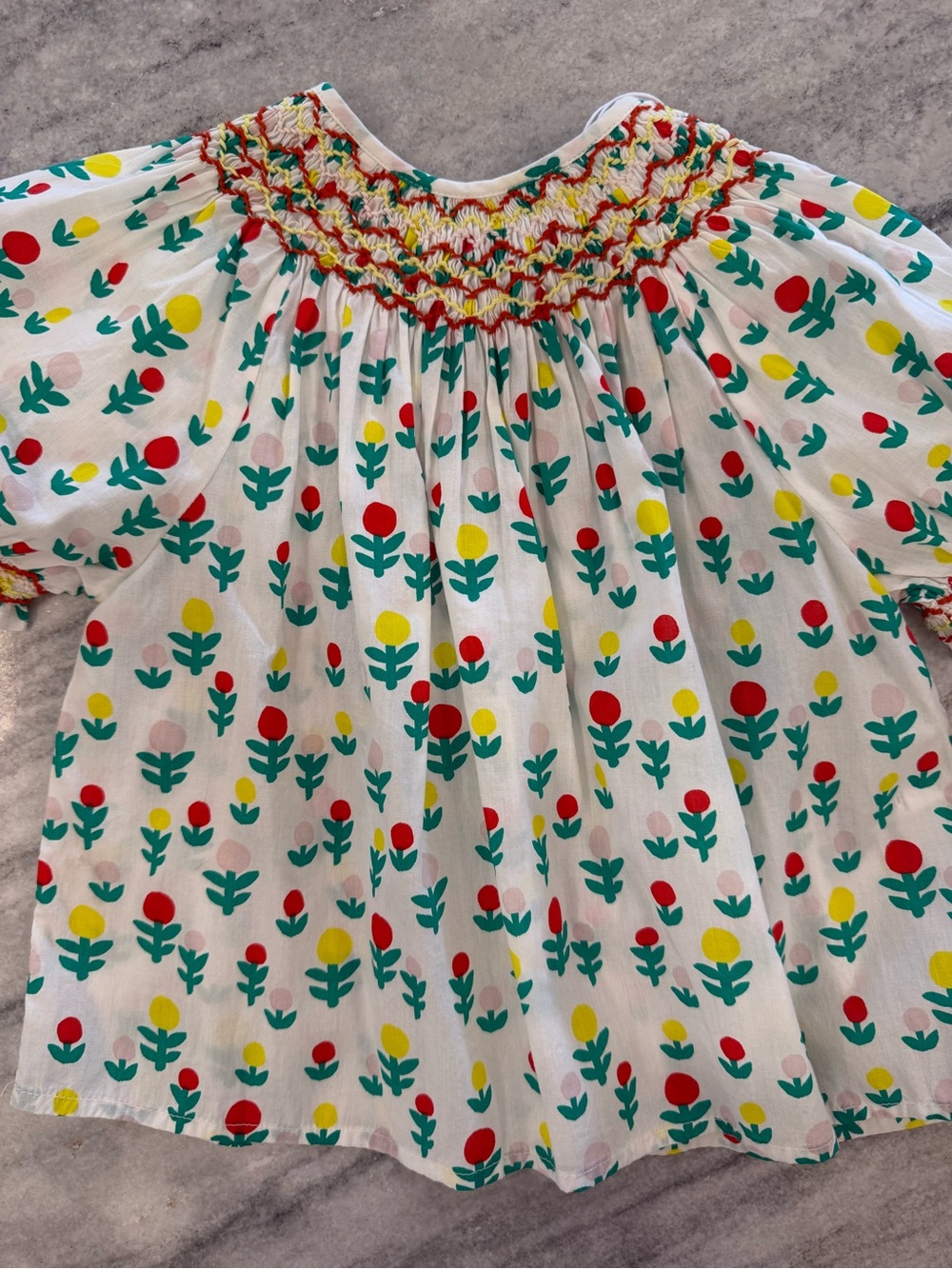 Stella McCartney Kids White Smocked Floral Blouse with Red, Yellow & Green